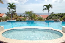 Royal Palm 1A is a fully equipped 2-level villa situated within the exclusive, centrally located and 24-hour secured Royal Palm Resort in Piscadera Bay. The airport, and Curacao's capital (Punda and Otrabanda) with its many shops and restaurants, and a few of the main beaches are just minutes away.  This fully air-conditioned, 5 bedroom, 3 bathroom and 2 kitchen villa, is large and comfortable enough to accommodate up to 8 persons. The main level is more luxurious and consists of an open kitchen, a living room and a dining area, 2 large bedrooms with double beds and ensuite bathrooms and a spacious (50 sq m!) porch with wonderful views of the ocean. On the lower level, the 3 bedrooms (2 twin beds and 1 double bed) share 1 bathroom. There is also a smaller kitchen with electric cooker and a small fridge. So if you are a large family, this is an ideal area for your kids.  Amenities, Piscadera