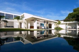 This ultra avant-garde, four-bedroom villa is located in the heart of Bali's fashionable Seminyak district, just footsteps away from Seminyak's sweeping beach, vibrant night scene, world-class restaurants and chic boutiques. A party villa for relaxation and play, the villa offers a captivating blend of luxury, recreation, party facilities, privacy, and exemplary service. Completed in 2007 and boasting funky tropical modern architecture, exemplified by an abundance of space, natural light and places to chill, the villa was designed by the well-known design firm Gfab. This luxury villa is centered on the pool and built around the pool to creat an enclosed courtyard and pool garden.The living areas of the villa are varied, with room inside and out suited for different use. The villa includes 4 equally-sized bedrooms with ensuite baths. Each of the four bedrooms is spacious and intended to offer guests the maximum discretion and room for private space. Ensuite bathroom feature all, with the upstairs baths enjoying natural lighting. The bedrooms themselves are fully appointed with desks, built-in closets, iPod docks and indirect diffused lighting. Taking an inspirational approach to modern lifestyle, the villa is constructed on two levels and set within a large walled garden. It presents a 25-meter swimming pool, outdoor jacuzzi, steam room, alfresco dining facilities and soundproof party room, in addition there is a secure carport at the main entrance.Service and Facilities, Seminyak