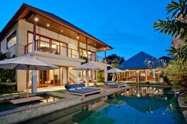 Perfectly situated 100 metres from Batu Belig Beach in Greater Seminyak, 30 minutes from the airport and minutes from the boutiques, restaurants and nightlife that make Seminyak so appealing, the elegant holiday villa embraces all the comforts and glamour of modern tropical living while preserving an exotic atmosphere and distinctive Balinese charm.Completed in August 2010, the contemporary Balinese architecture of this luxury villa features a living room and dining room pavilion, a four bedroom pavilion, an entertainment room and business centre, and an open air 'bale' lounge pavilion in the spacious gardens with a 12 meter swimming pool and outdoor jacuzzi. The architect's other work can be seen in some of Seminyak's finest venues including Ku De Ta. The owner has made every effort to employ 'green friendly' technologies in the construction of this beautiful rental villa.Hidden behind a walled enclosure reminiscent of a traditional Balinese village and ensuring the utmost in privacy, guests enter through an imposing wooden door, a modern interpretation of Majapahit period palace entry gate leading to a seated Buddha water feature, vine shrouded Koi pond and stepping stones leading to an exotic garden and 16 meter lap pool. The villa boasts two master bedrooms downstairs and a third master bedroom upstairs with a twin bedroom next door, each attached with lavish bathrooms, flat screen TVs and built in wardrobes.Services and Facilities:, Seminyak
