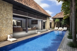 The villa at Echo Beach is situated just a small walk from Echo Beach, a fishing village of Canggu on Bali’s south west coast. This four bedroom, contemporary styled villa presents open air living alongside a 14-metre swimming pool.The property comprises an expansive, open air living and dining area, an audio visual room, four air conditioned bedrooms each with ensuite bathrooms, and numerous relaxation areas. The long corridors and high ceilings present a feeling of enormous space.fresh white walls, polished cement floors, honey-coloured serai stone and dark timber accents form the primary colours, offset by the Villa’s deep-blue tiled pool and rich green lawns. Large pieces of artwork adorn the walls, while furnishings, artefacts, accessories and lighting are all of the highest quality. Services & Facilities, Canggu